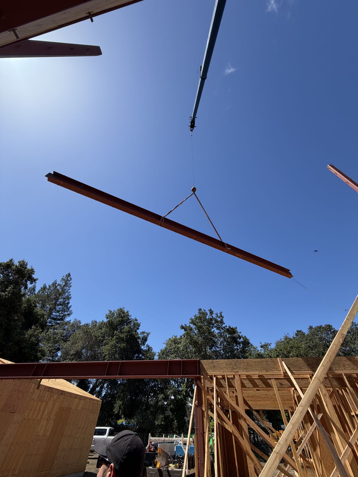 Steel beam being lifted into place by a crane